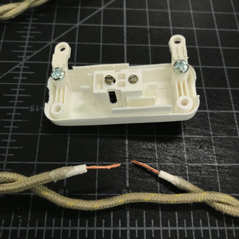 open vintage slim switch and twisted pair wire with insulation stripped