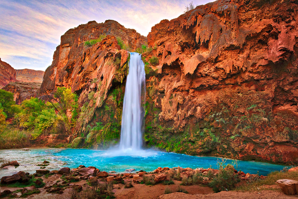 Stunning turquoise Havasu Falls amidst red canyon walls, a hidden gem in the Grand Canyon National Park