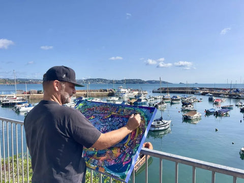 devon artist gustav szabo aka szabotage live painting en plien air paignton harbour in a graffiti street art style