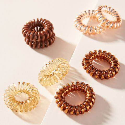 Invisibobble original brown and clear ring kink hair ties on pastel background