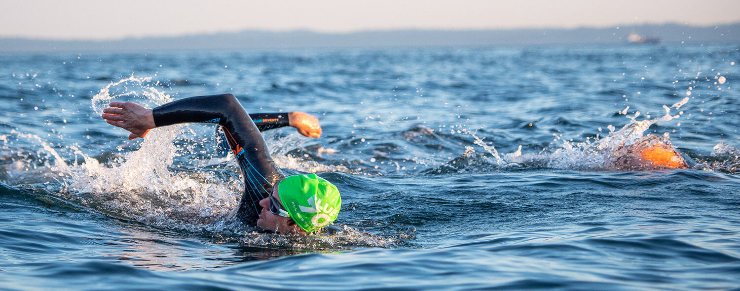 Open water swimmers in reaction wetsuit