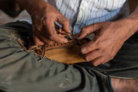 man's hands with barehands leather shoes