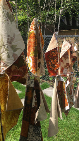 vintage fabrics hanging outdoors on a clothesline