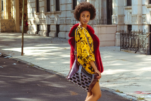 woman crossing the brooklyn street in doc martens and velvet handbag