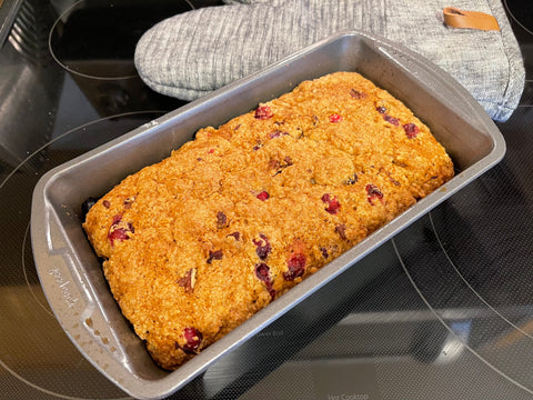 baked cranberry orange bread in metal loaf pan