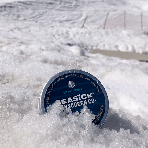 plastic free tin of sunscreen sitting in the snow