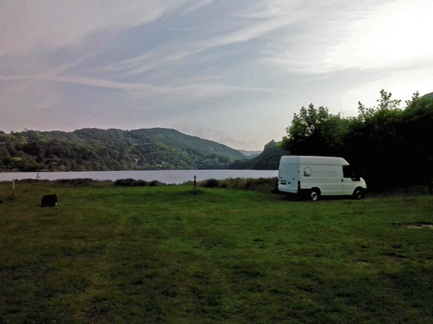 Van parked at campsite near lake