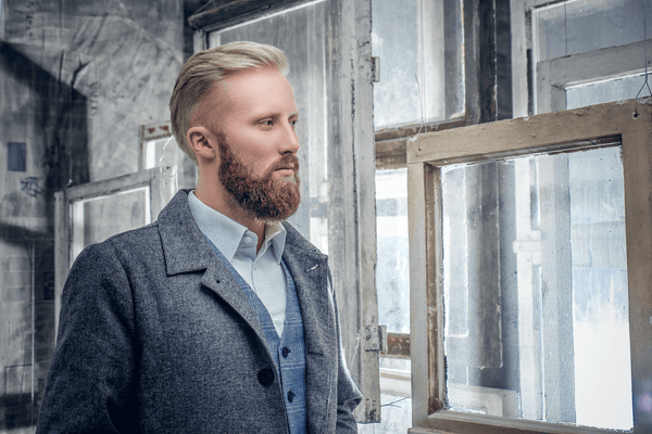 Bearded man in a gray room