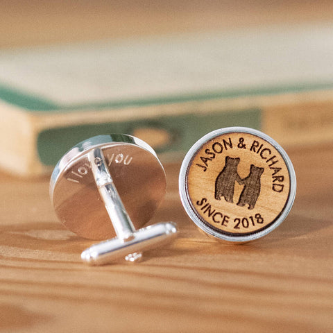 A pair of silver plated cufflinks with beautiful engraved cherry wood, featuring two bears holding hands in the centre. The names 'Jason & Richard' are engraved above the bears, and 'Since 2018' in engraved underneath them. The words 'I love you' are engraved into the metal on the back of the cufflinks.