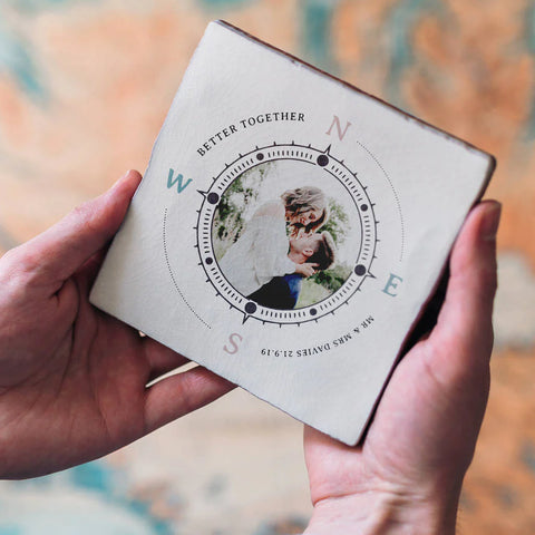 A square ceramic tile featuring a compass design with a photograph of a couple in love in the centre. Personalised texts surrounds the compass - "Better Together, Mr & Mrs Davies 21.9.19"