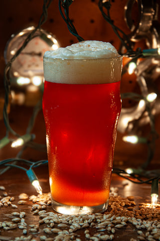 Glass of holiday ale in front of Christmas lights