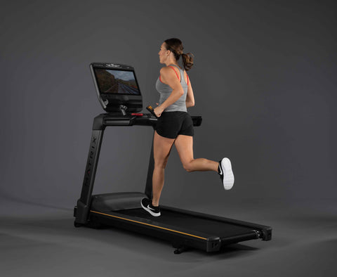 Woman running on Matrix Fitness Commercial treadmill