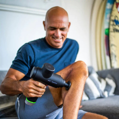 Man using Hyperice Massage Gun on his calf to relieve muscle soreness