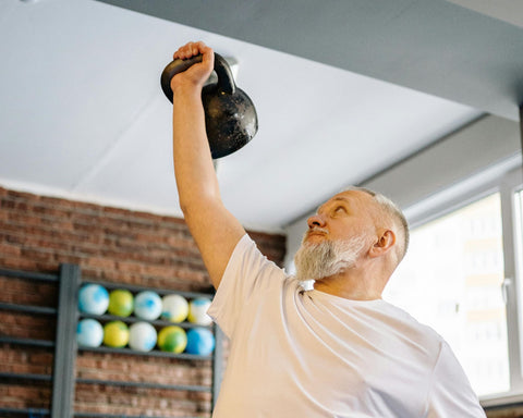 Man using a kettlebell in his home gym
