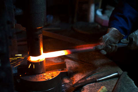 blacksmith forging a blade