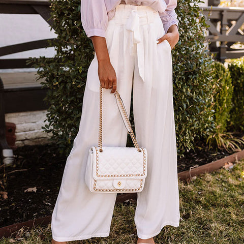 Make a bold outfit choice with our chic white 'Hazelle' trousers featuring lightweight material, a high waistline with a matching belt, a hidden zip and hook closure, accent side pockets, and a relaxed pants silhouette that falls straight into ankle-length hemlines!