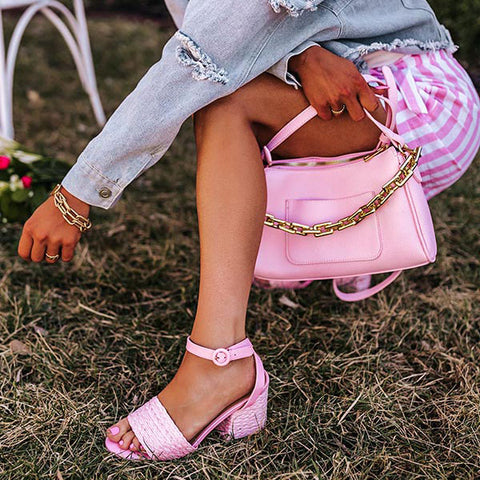 Complete your look with a pop of color with our cute pink 'Milady' heel featuring a wide over-the-foot strap, a rounded open toe, a 3.5-inch block heel, and a buckled ankle strap! This heel runs more true to size.