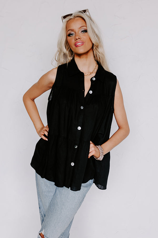 Black sleeveless tunic top with button front