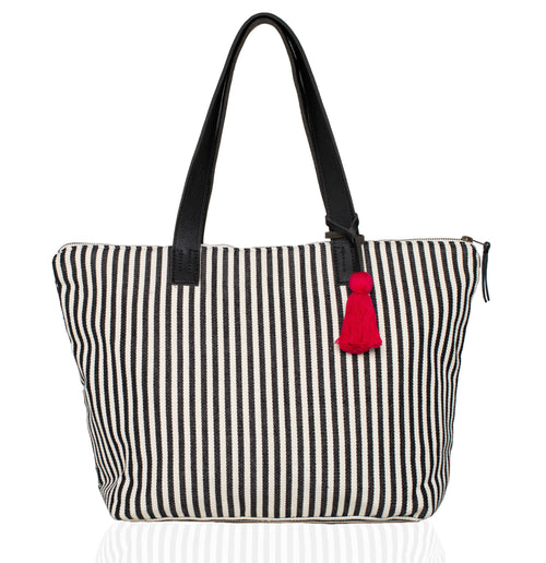 Hand woven artisan Estella tote in vertical black and white stripes on white background