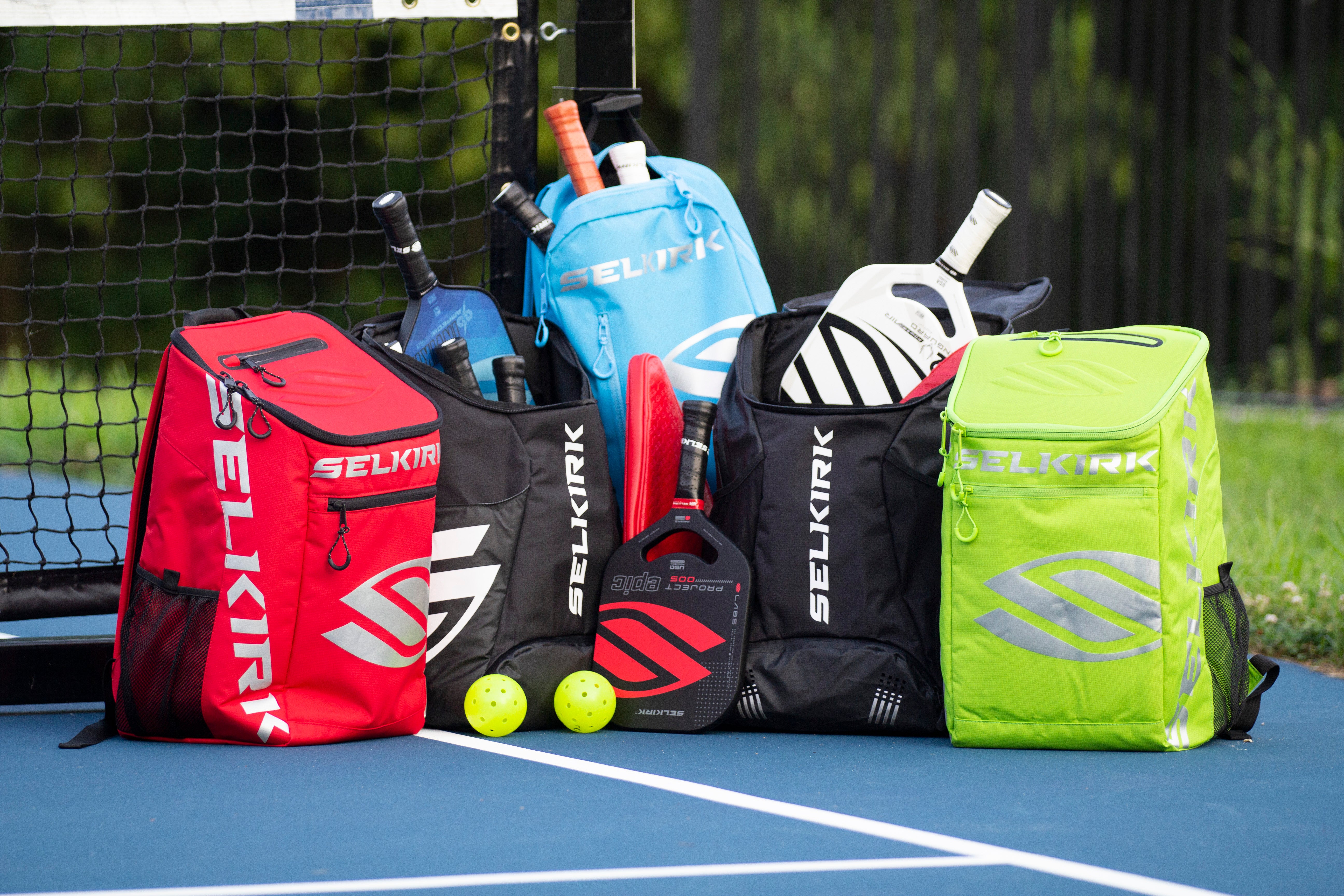 5 different pickleball bags on a pickleball court
