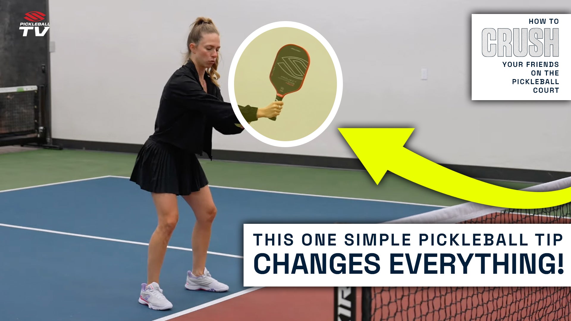 Kaitlyn Kerr stands at the kitchen line with a proper ready position. Her knees are bent and she is holding the pickleball paddle in front of her at chest height.