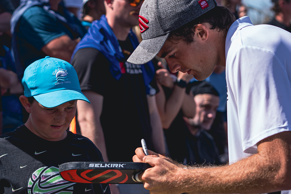 James Ignatowich signing a paddle for a fan at the Red Rock Open