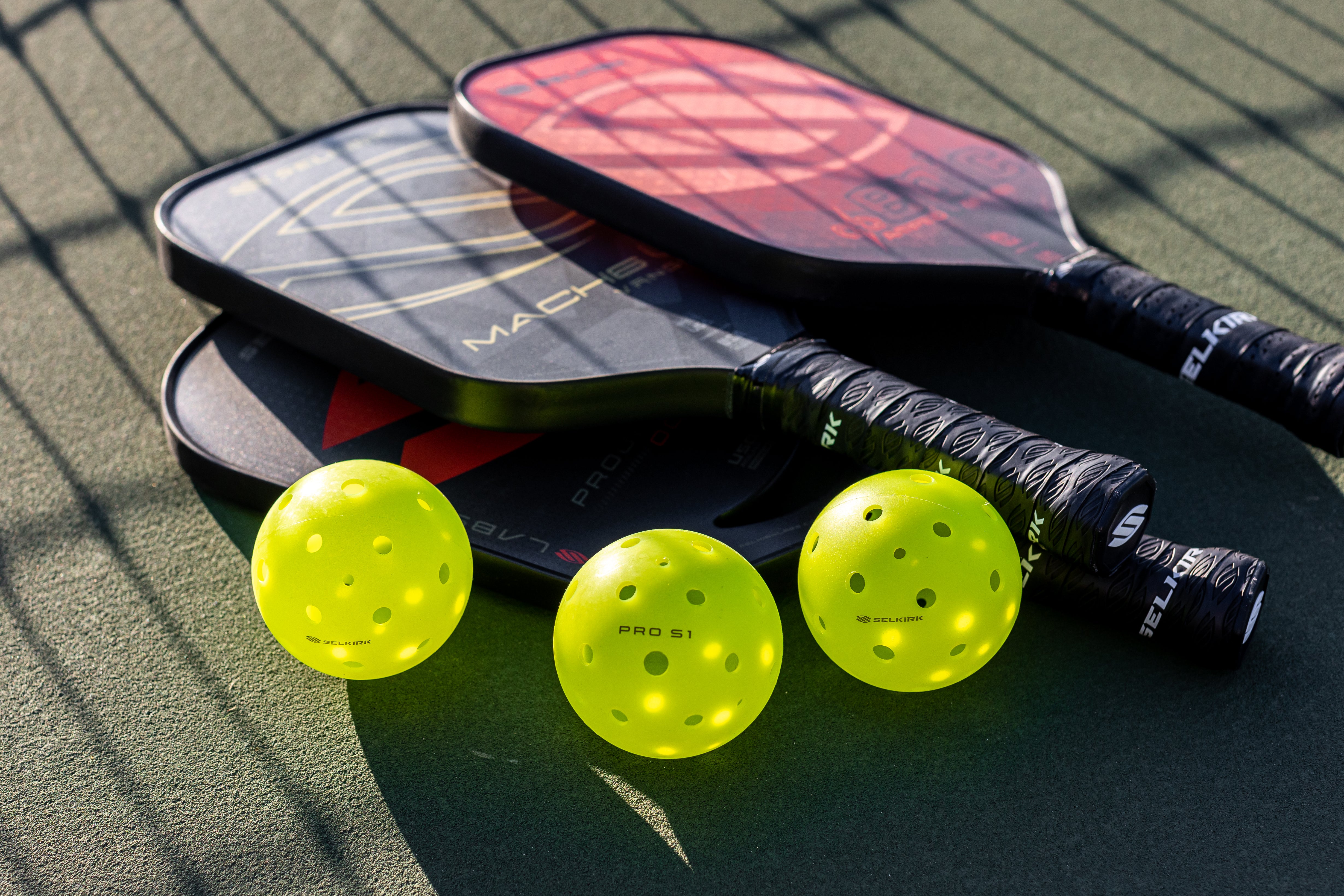 Different pickleball paddles can be used for singles and doubles matches.