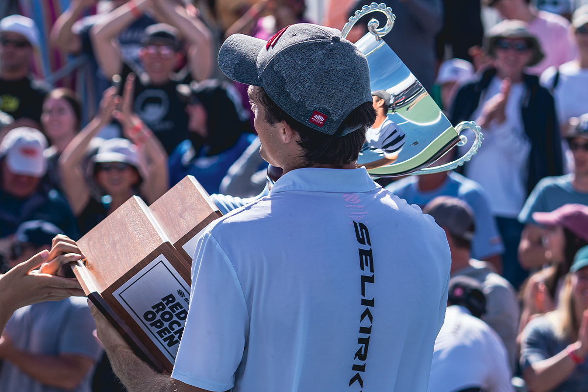 Pro pickleball athlete James Ignatowich holding the mixed doubles trophy after winning the title at Red Rock Open