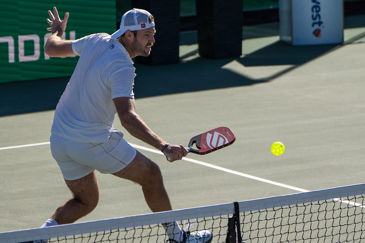 Selkirk pro athlete Jack Sock playing with the Luxx paddle in red.