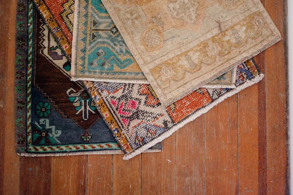 a stack of tiny Turkish rugs