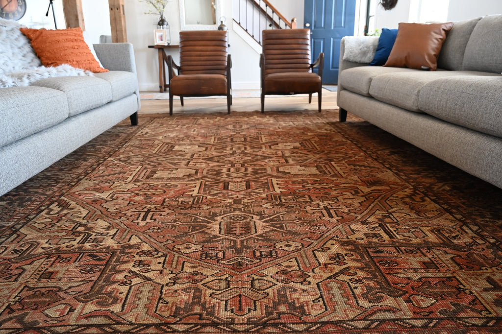 A large vintage rug in a living room.