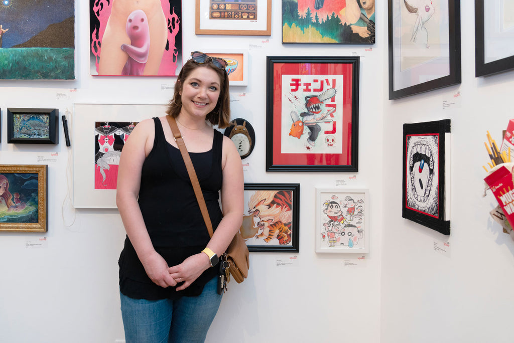 Artist Betsy Bauer in front of her original "Legendary Fire" artwork for Anime in LA