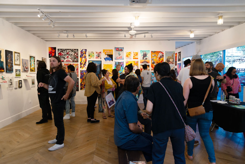A group of visitors enjoying the artwork from Anime in LA