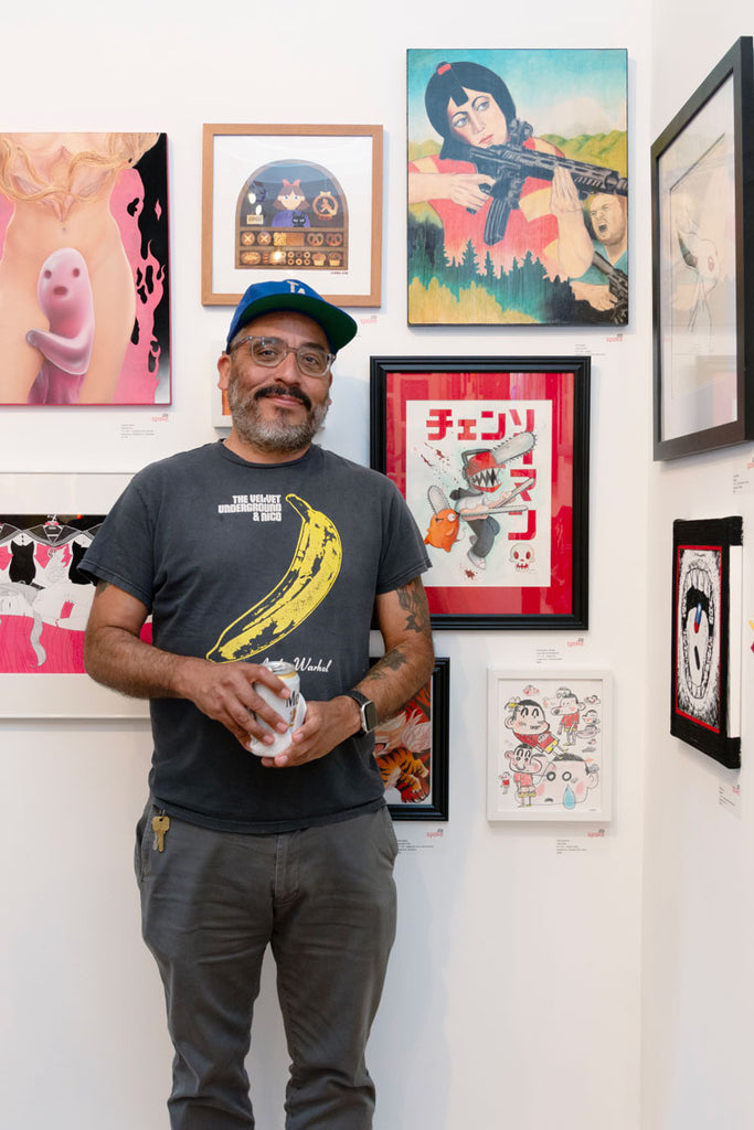 Artist Ken Garduno in front of his "Shin-chan" inspired artwork for Anime in LA