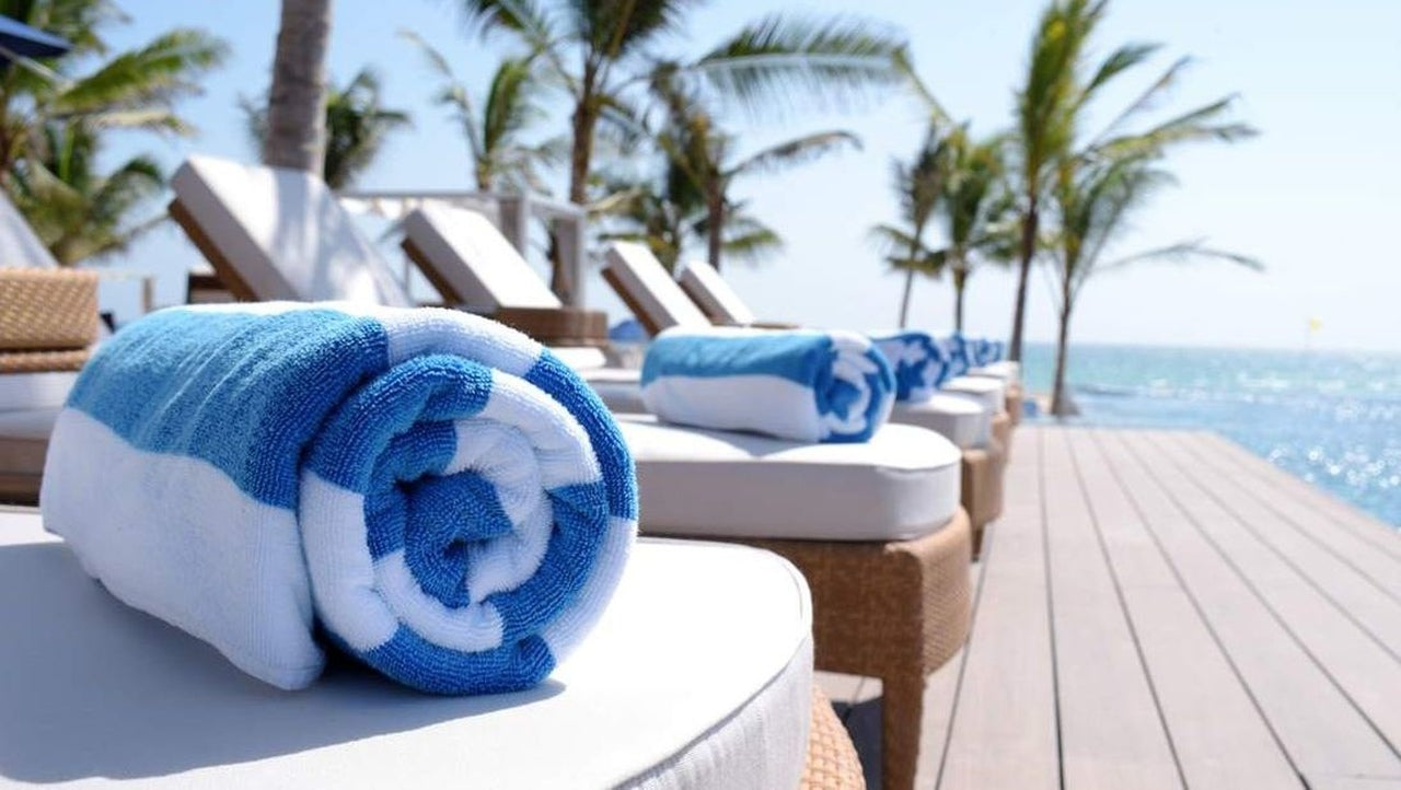 beach towel, rolled beach towels on the sunbeds near the beach