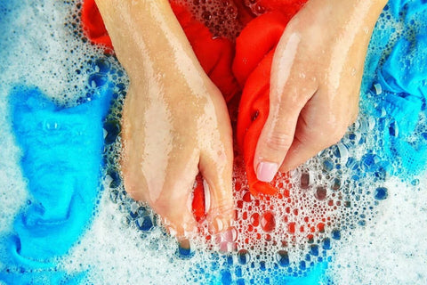 washing clothes by hand with soap bubbles