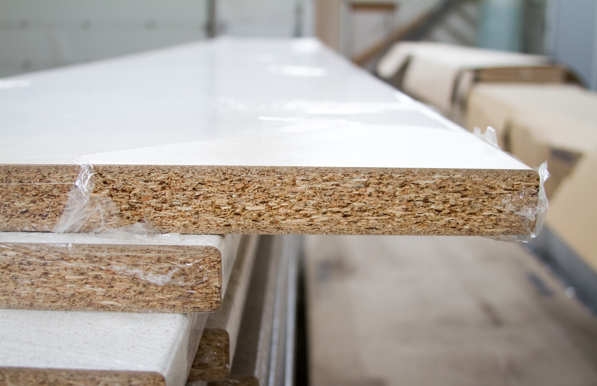 Particleboard stored inside a ripped plastic