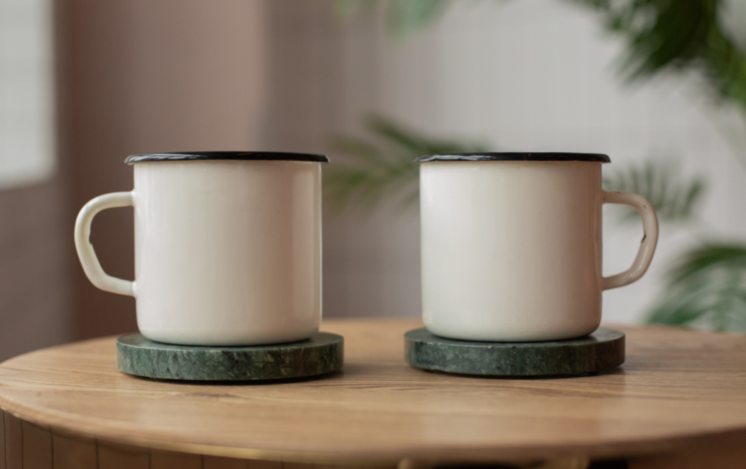 Mugs placed on top of coasters to protect suar wood table top