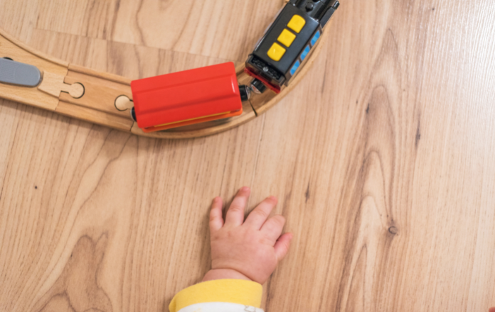 Baby playing on suar wood flooring