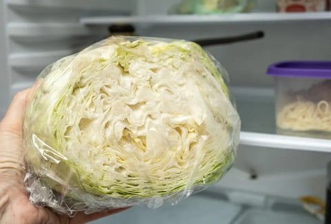 A picture of a white cabbage storing in the fridge