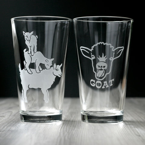 Goat Pint Glasses with goats balancing on top of each other, or one baby goat face with the word "GOAT" beneath it