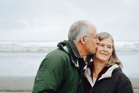 Older couple being active on the beach