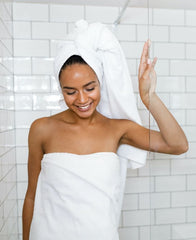Woman takes a less warm shower to protect her skin in winter
