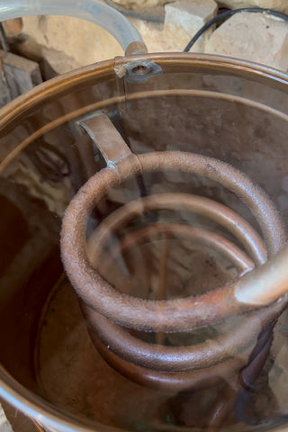 The still coil is cooled through the cold water condenser.