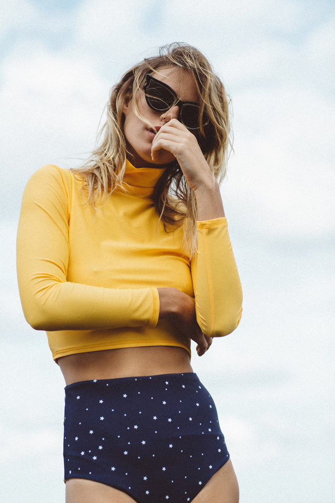 Montana Lower wears Salt Gypsy sustainable ocean activewear. The Navy & Gold Collection 2017 | www.saltgypsy.com #saltgypsy #activewear #activeswim #beachactive #womenwhosurf #surf #sustainableswim