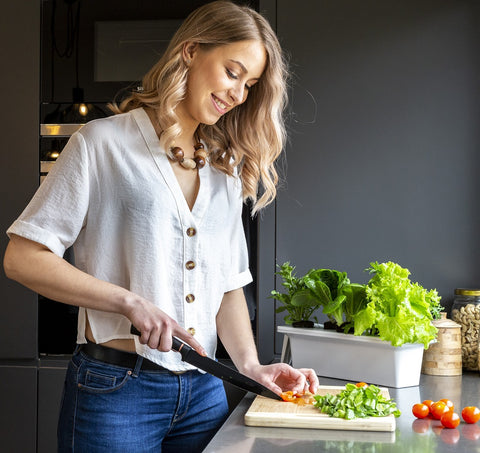 Woman preparing a meal using fresh food.