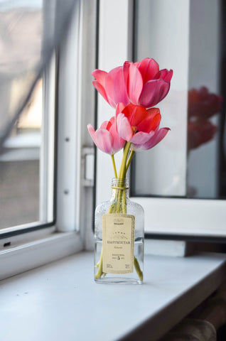 Flowers displayed in a glass bottle.