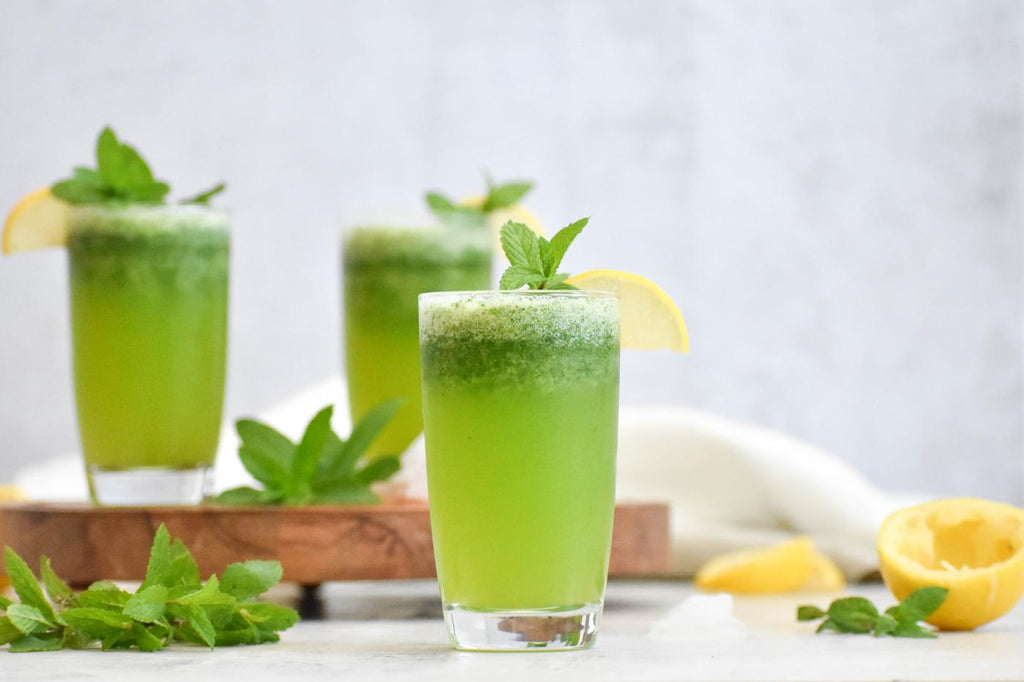 A green drink garnished with peppermint.