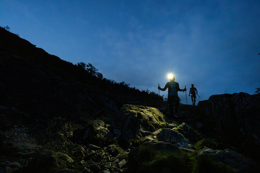 Ultra trail runners light up a trail by head torch as they make a descent during 13 valleys ultra 2023