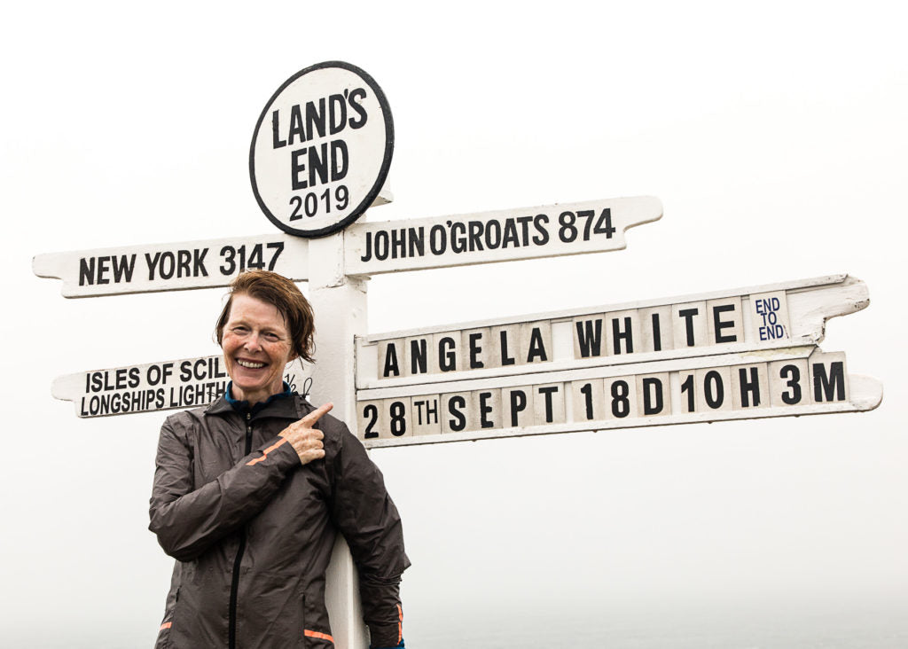 The running granny, angela white, stood at the Land's End signpost having run there from John O'Groats